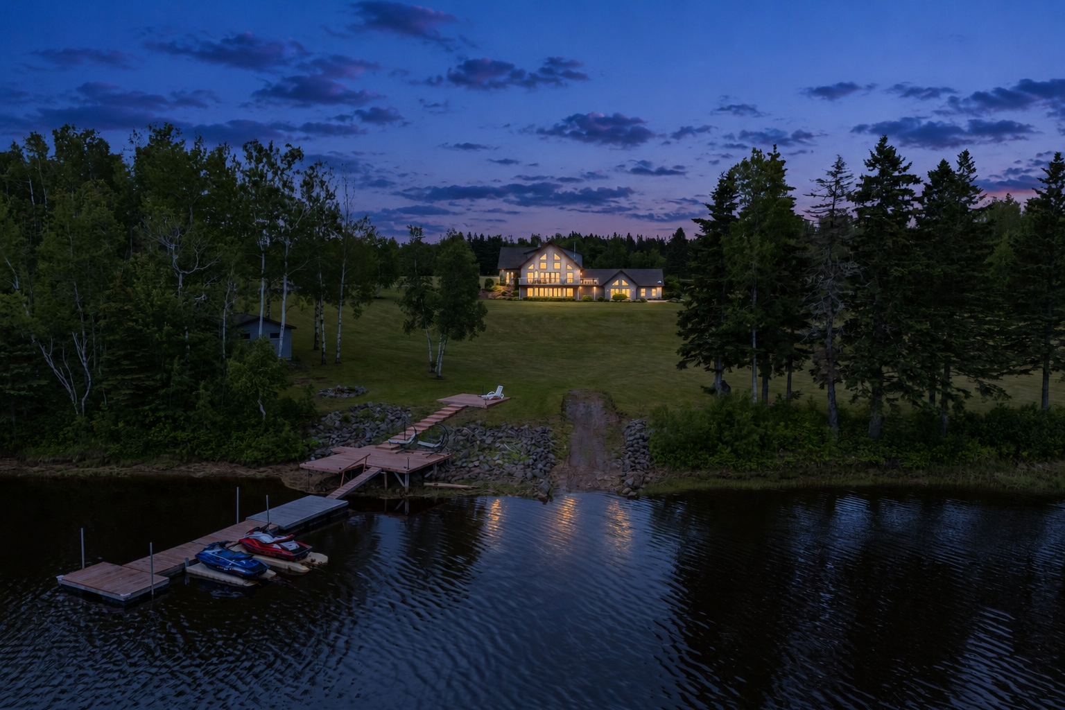 660 Chemin St-Charles Sud at dusk — waterfront estate with dock